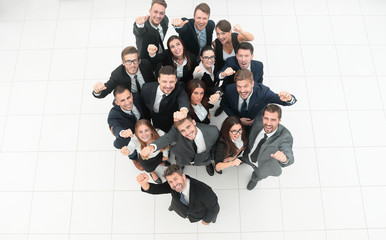 Fototapeta na wymiar concept of success. business team raising hands and looking at camera.