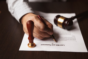 Notary's public pen and stamp on testament and last will.