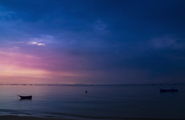 Naklejka na ściany i meble Sunset with blue twilight on seascape background