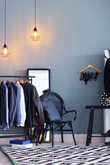 Dressing room interior with clothes on rack. Fashionable wardrobe