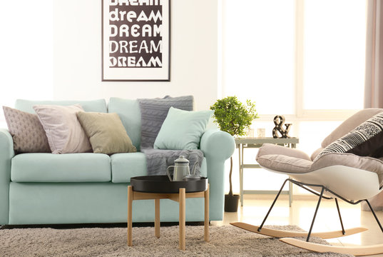 Living room interior with comfortable mint couch