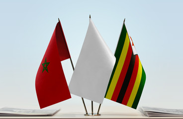 Flags of Morocco and Zimbabwe with a white flag in the middle