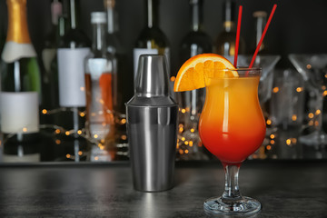 Bar counter with glass of cocktail Sex on the Beach