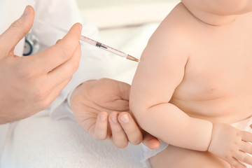 Obraz na płótnie Canvas Doctor vaccinating little baby, closeup
