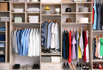 Big wardrobe with different clothes for dressing room