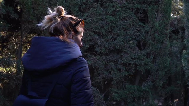 Young woman in a winter jacket going through a large maze