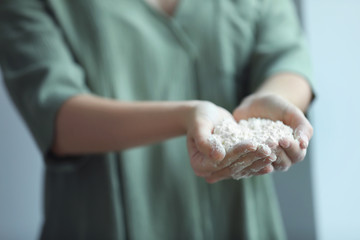 Woman holding flour in hands, closeup
