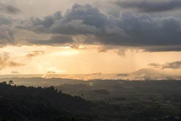 scene raining among a mountains during sunset