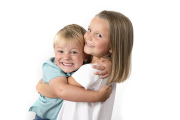 7 years old adorable blond happy girl posing with her little 3 years old brother smiling cheerful isolated on white background