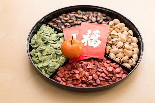 Snack tray for lunar new year with red packet of word means luck