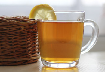Tea with lemon in a glass mug. 