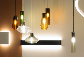 Modern style lamps in interior design. Decoration with different form lampshades combination