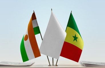Flags of Niger and Senegal with a white flag in the middle