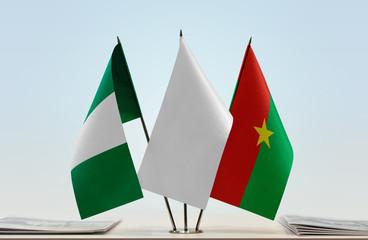 Flags of Nigeria and Burkina Faso with a white flag in the middle