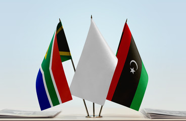 Flags of Republic of South Africa and Libya with a white flag in the middle