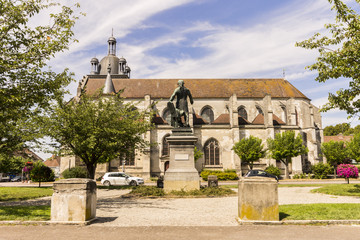 Fototapeta na wymiar The Place de la République, with the statue of Georges Jacques Danton and the Church of Saint-Étienne in the background. Arcis-sur-Aube, Grand Est, France