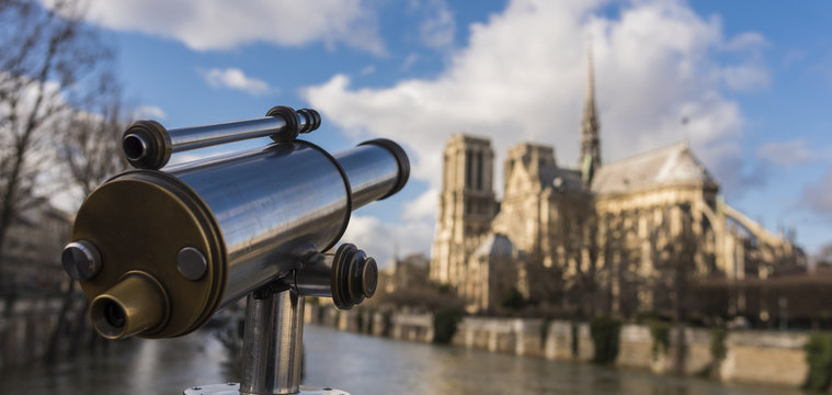 Tourist binoculars at notre dame de paris cathedral on cite island
