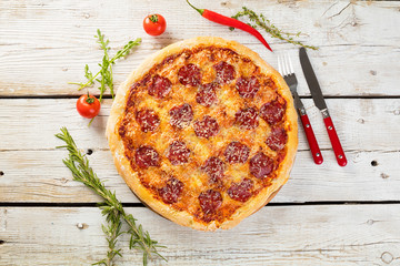 Delicious pizza served on wooden plate 