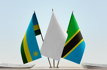 Flags of Rwanda and Tanzania with a white flag in the middle