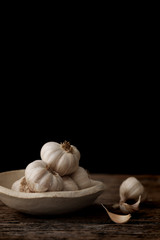 Still life of garlic bulb in dark black background