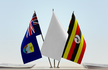 Flags of Saint Helena and Uganda with a white flag in the middle