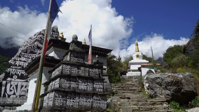 Buddhist stupa and traditional prayer stone with a Buddhist mantra: om mani padme hum. Translation: Pearl in a lotus flower! Nepal. 4K