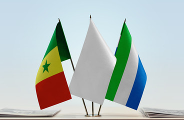 Flags of Senegal and Sierra Leone with a white flag in the middle
