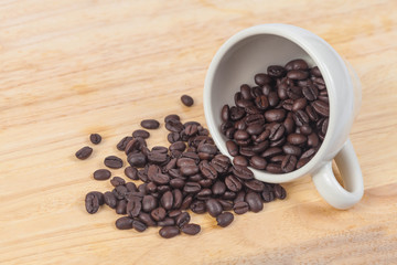 coffee beans in white cup on wood table