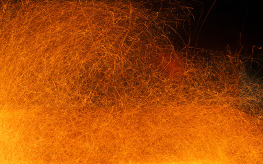 Sparks of fire on a black. Abstract  background with fire sparks.