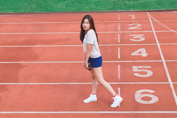Obraz premium Fashion portrait of Hipster teen girl wear casual clothes,posing on running track.