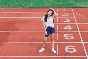 Fototapeta premium Fashion portrait of Hipster teen girl wear casual clothes,posing on running track.