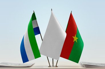 Flags of Sierra Leone and Burkina Faso with a white flag in the middle