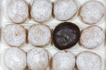 Krapfen covered with sugar and chocolate