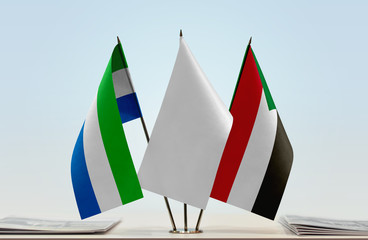 Flags of Sierra Leone and Sudan with a white flag in the middle