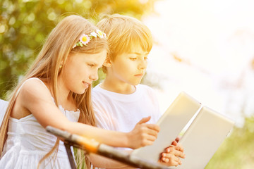 Zwei Kinder spielen mit Tablet Computer im Internet