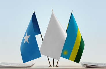 Flags of Somalia and Rwanda with a white flag in the middle