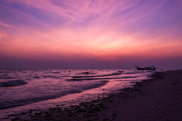Early morning dramatic violet sky over sea beach before sunrise at Laoliang island, Trang province, Thailand.