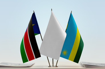 Flags of South Sudan and Rwanda with a white flag in the middle