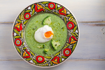 Broccoli spinach soup and poached egg. Vegetable vegetarian soup, healthy food. Creamy soup. View from above, top, horizontal
