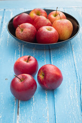 Red apples on a wooden table background