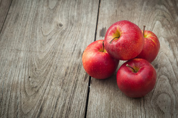Red apples on a wooden table background
