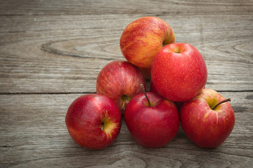 Red apples on a wooden table background