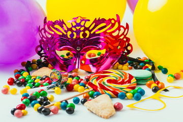 close up view of balloons, masquerade masks and candies, purim holiday concept