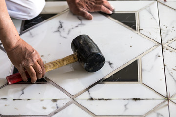 Industrial construction men worker granito tiler builder on floor