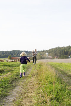 Man with his daughters on farm in Bergum, Sweden