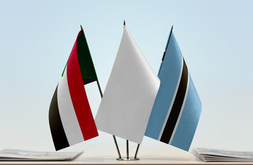 Flags of Sudan and Botswana with a white flag in the middle