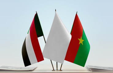 Flags of Sudan and Burkina Faso with a white flag in the middle