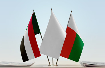 Flags of Sudan and Madagascar with a white flag in the middle