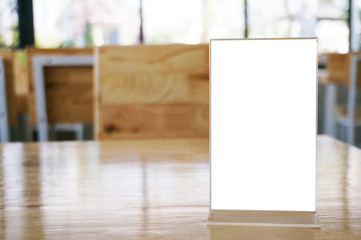 Mock up Menu frame standing on wood table in Bar restaurant cafe. space for text