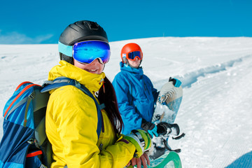 Fototapeta na wymiar Image of happy couple with snowboard on background of snowy hills
